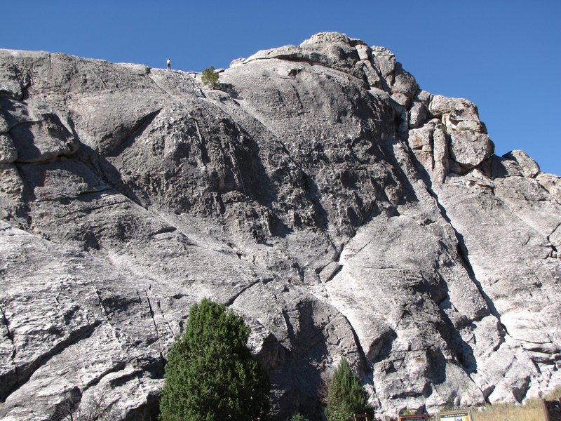 Climber reaching the top of Bath Rock