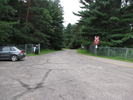 Parking lot.  Walk on the right side, through the gate