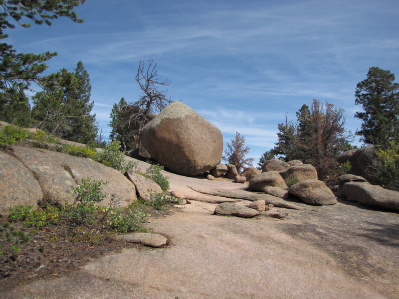 Trail heads to the right of the large boulder