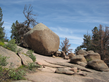 Trail heads to the right of the large boulder